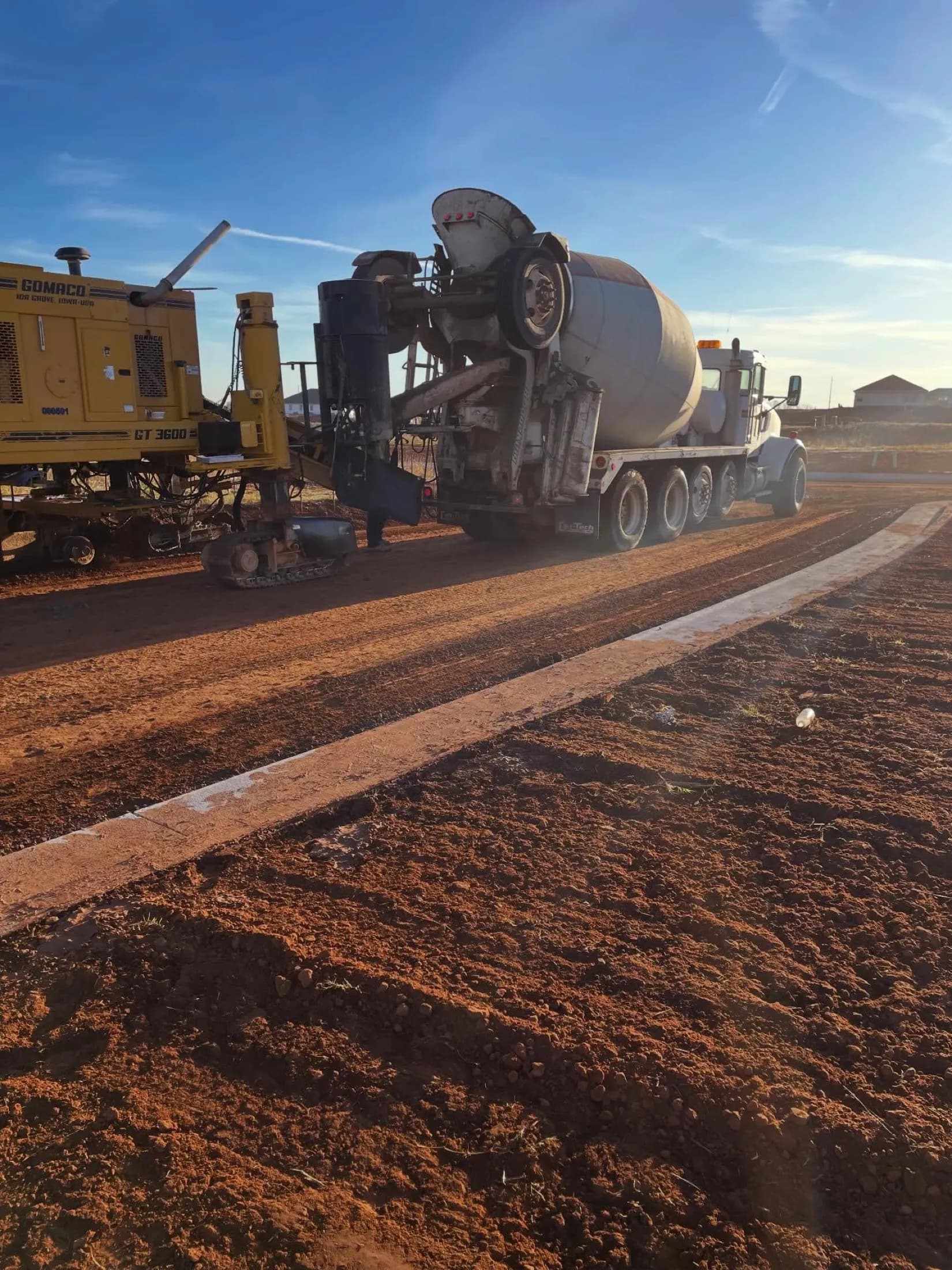 Concrete slipform paving at sunrise
