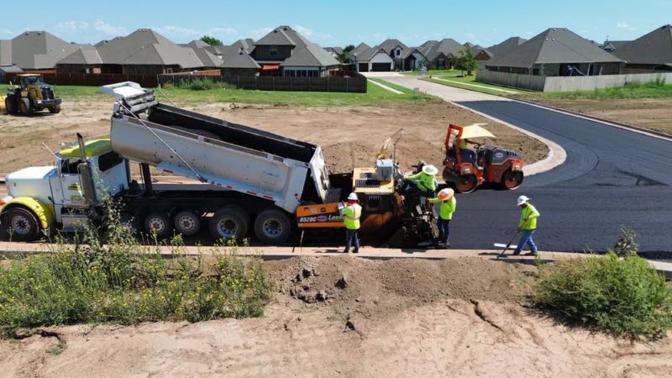 Aerial view of a First Water crew paving a new subdivision