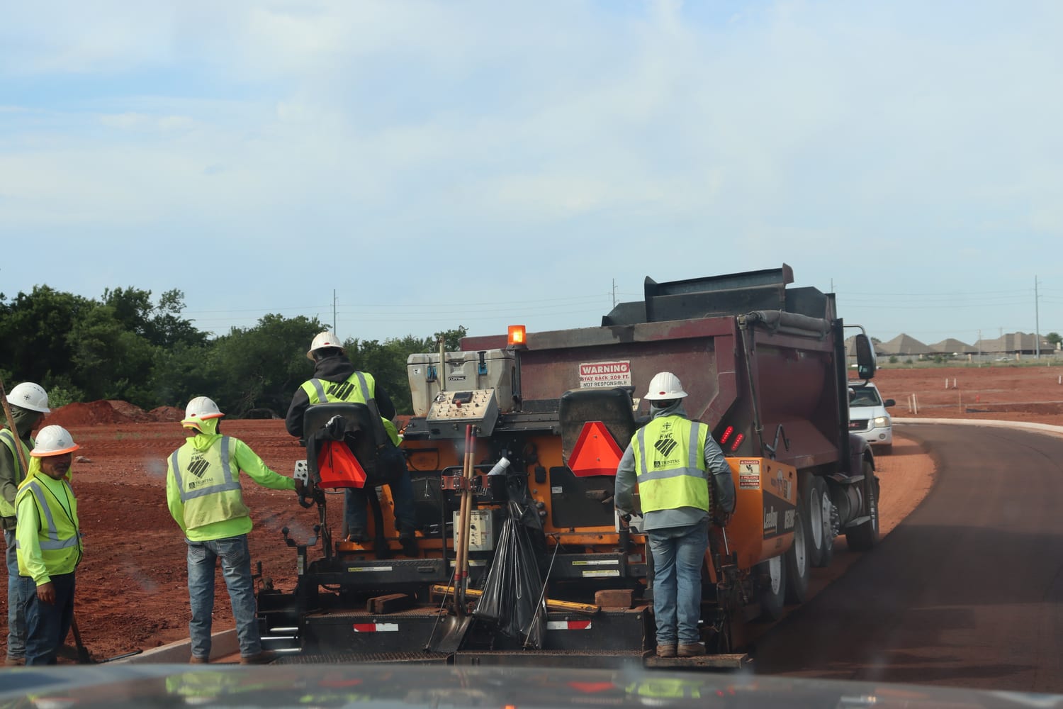 A First Water paving crew working behind a LeeBoy paver on a new Oklahoma City road
