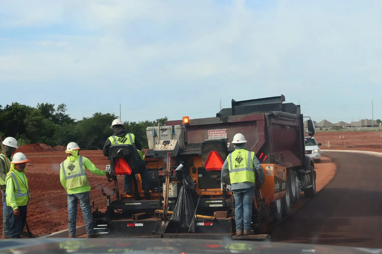 A First Water paving crew working behind a LeeBoy paver on a new Oklahoma City road