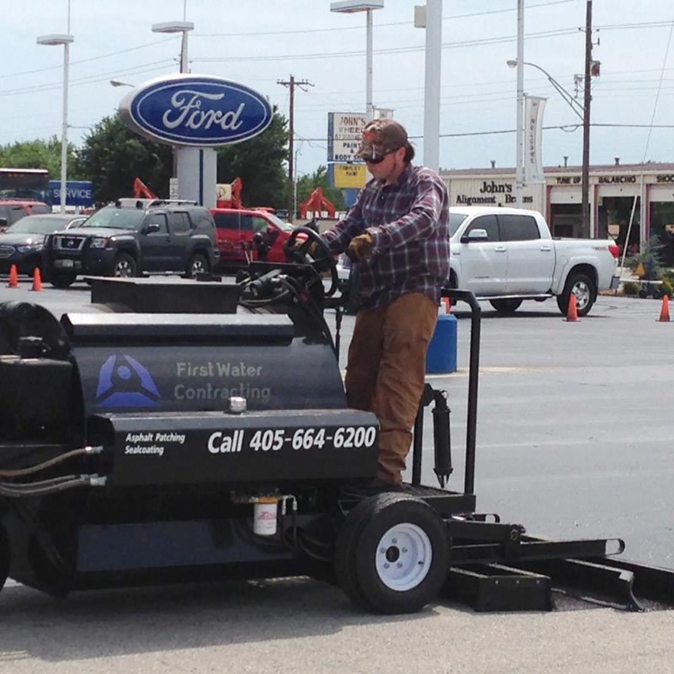 First Water branded sealcoating machine working a dealership lot